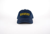 Navy blue cap with 'HONEY' embroidered in yellow on a white background